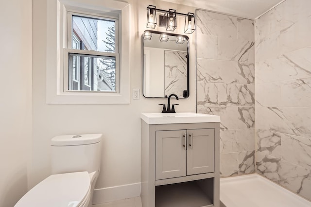 bathroom with vanity, toilet, and a tile shower