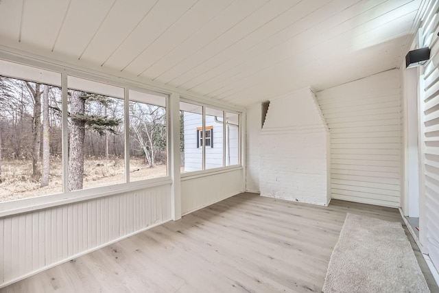 unfurnished sunroom featuring lofted ceiling