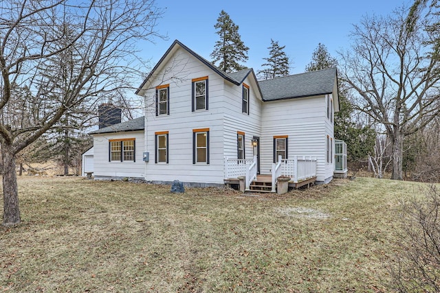 view of front of house featuring a front lawn and a deck