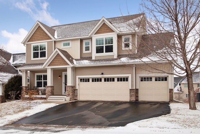 craftsman-style home with central AC and a garage