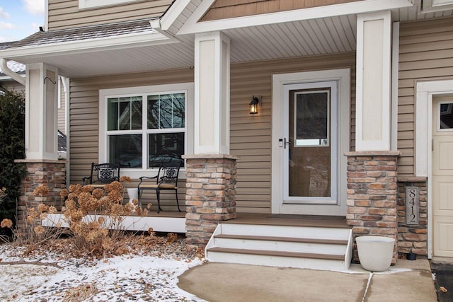 view of snow covered property entrance