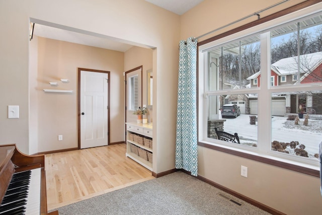 view of carpeted foyer entrance