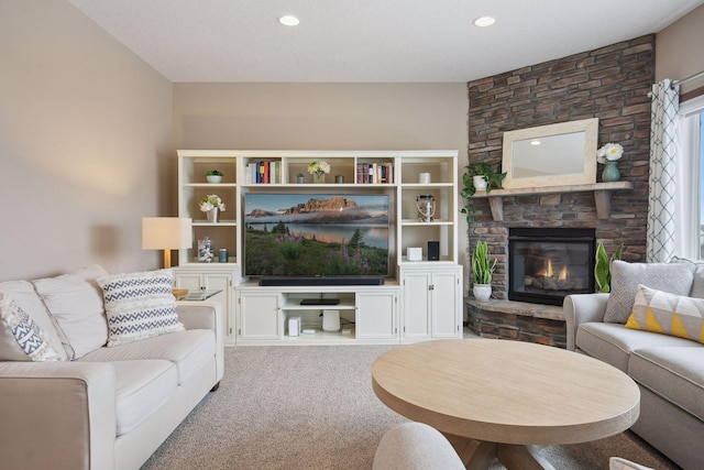 living room with a stone fireplace and light colored carpet