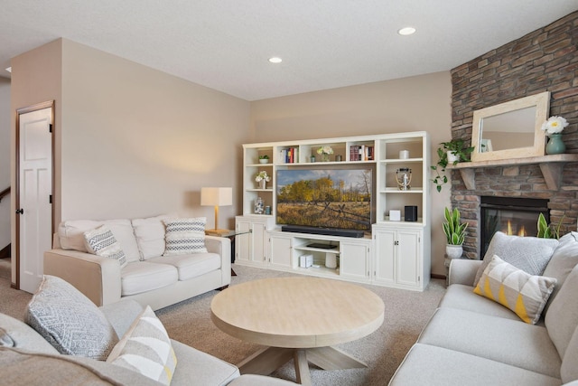 carpeted living room featuring a fireplace