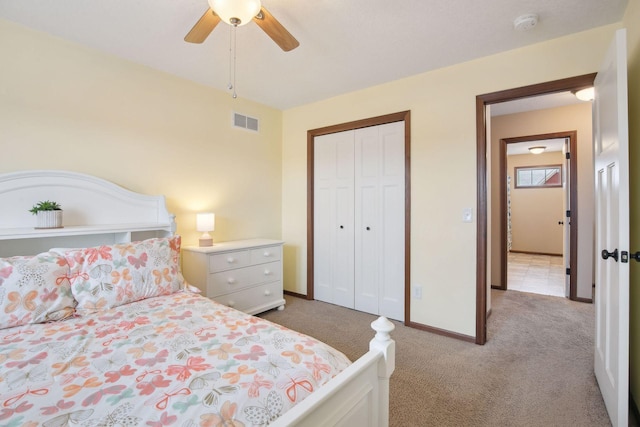 bedroom with light carpet, ceiling fan, and a closet