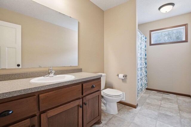 bathroom featuring vanity, toilet, and a shower with shower curtain