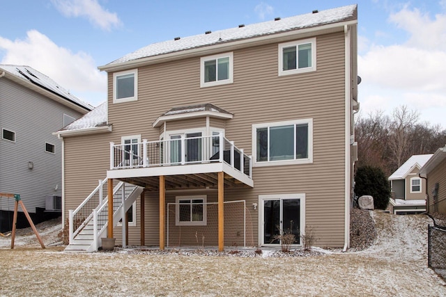 back of property featuring cooling unit and a deck