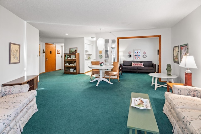 living room with carpet floors and a textured ceiling