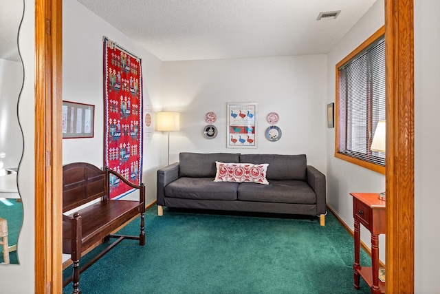 living room featuring a textured ceiling and dark colored carpet