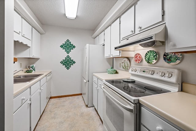 kitchen featuring light countertops, white appliances, a sink, and under cabinet range hood