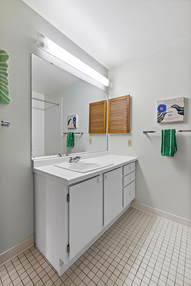 bathroom featuring tile patterned flooring, vanity, and baseboards