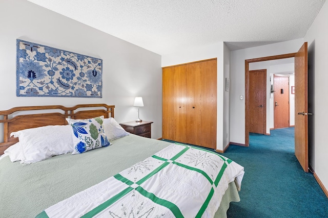 carpeted bedroom with a closet and a textured ceiling