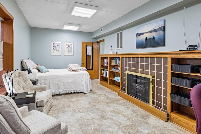 bedroom with a fireplace and visible vents