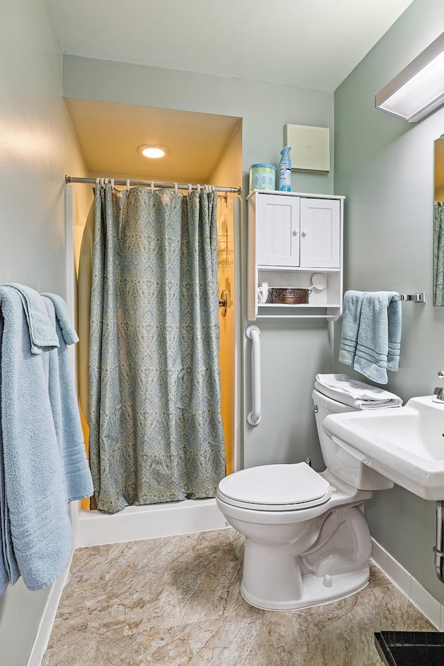 bathroom with sink, toilet, and a shower with shower curtain