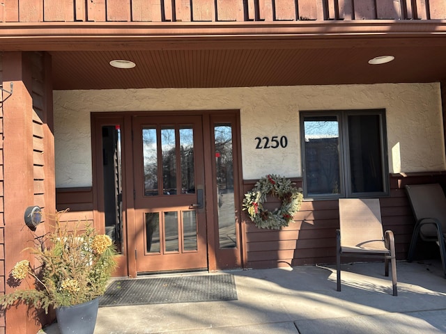 entrance to property featuring stucco siding