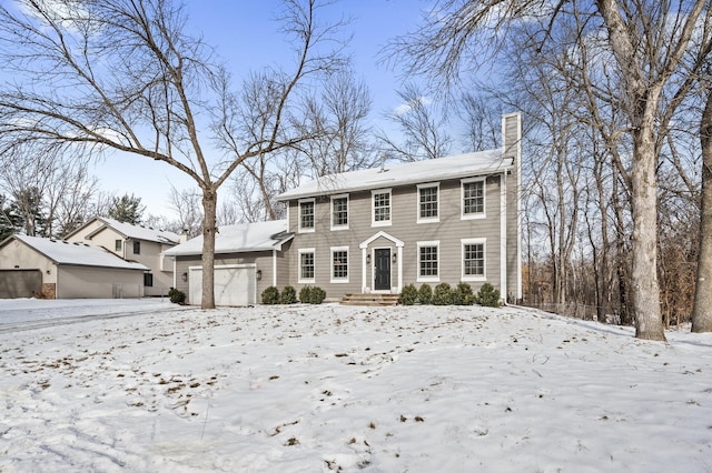 colonial inspired home featuring a garage