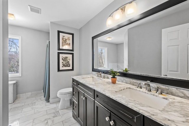 bathroom featuring toilet and vanity