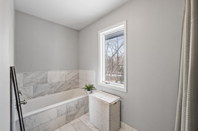 bathroom featuring tiled bath and tile patterned floors