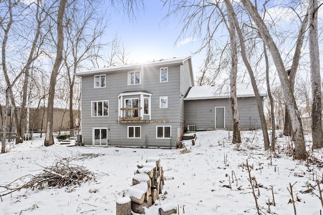 snow covered property with cooling unit