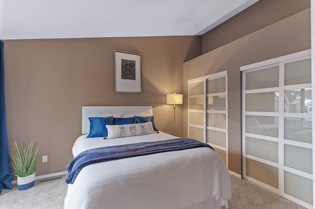 bedroom with carpet and lofted ceiling