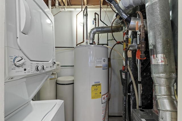 utilities featuring water heater and stacked washer and clothes dryer