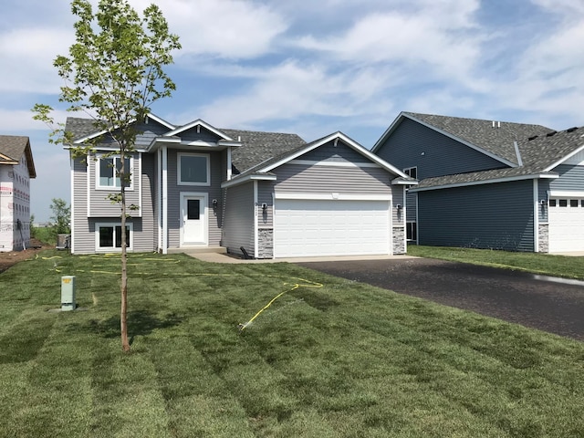 view of front of home featuring a garage and a front lawn