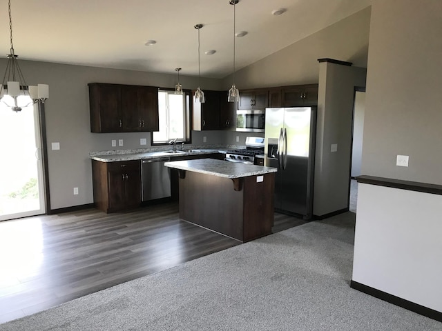 kitchen with a center island, stainless steel appliances, pendant lighting, lofted ceiling, and dark brown cabinets