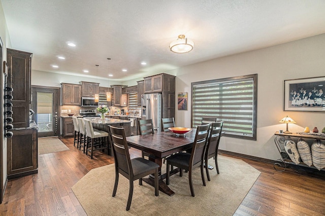 dining space with dark wood-type flooring and a wealth of natural light