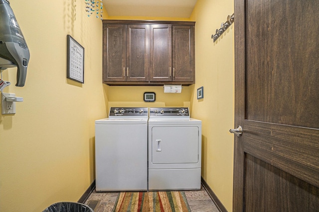 washroom featuring cabinets and washing machine and clothes dryer