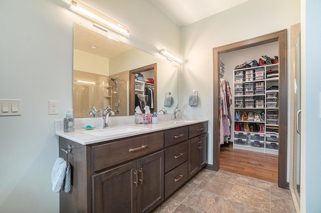 bathroom with wood-type flooring, vanity, and walk in shower