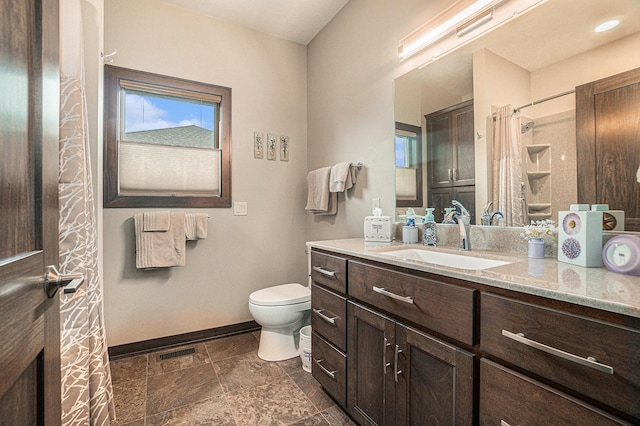 bathroom with vanity, curtained shower, and toilet