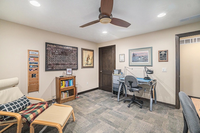 carpeted home office featuring ceiling fan