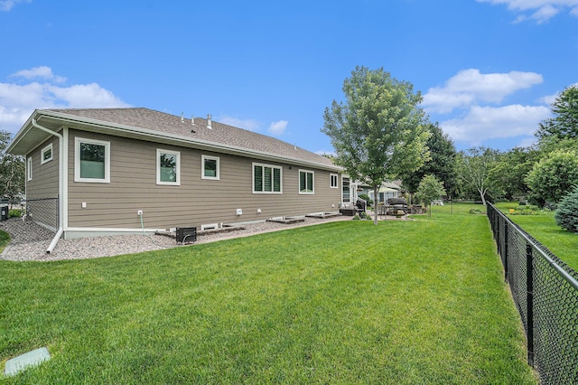 rear view of property with a lawn