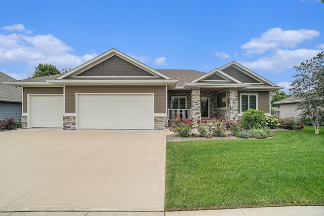 craftsman-style house featuring a front lawn and a garage