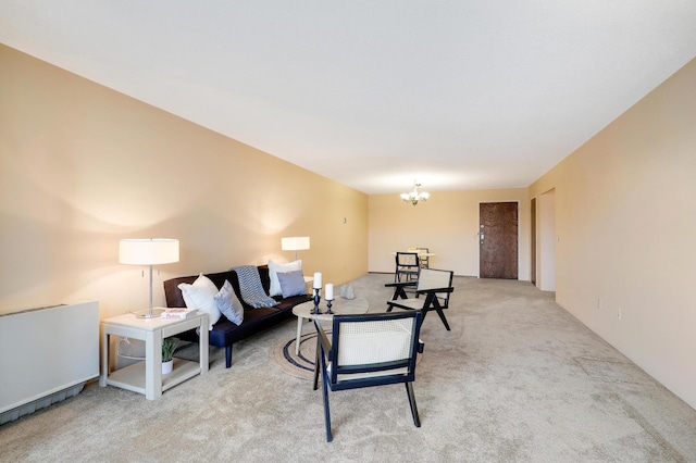 living area with light carpet and an inviting chandelier