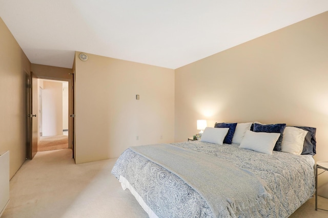 bedroom featuring light colored carpet