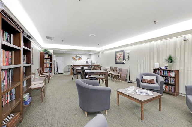 carpeted living area featuring visible vents