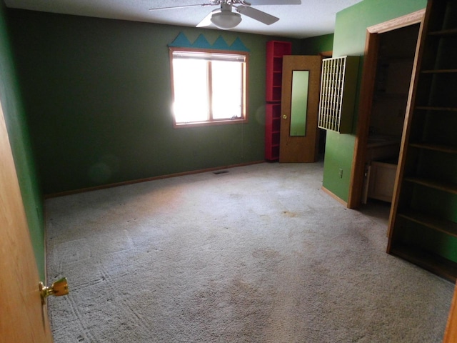 unfurnished bedroom with carpet, ceiling fan, and a closet