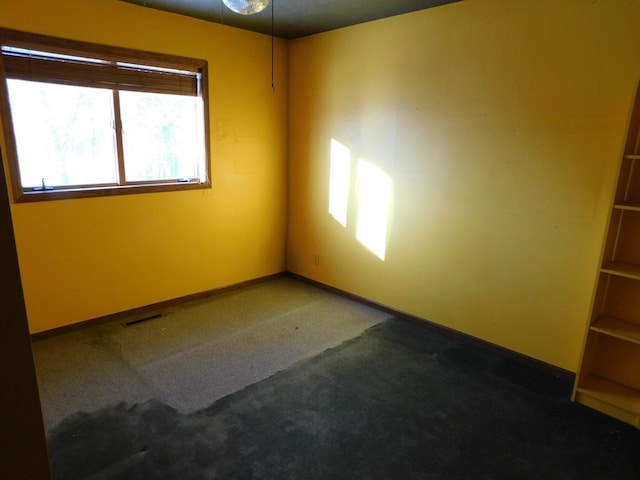 empty room with dark carpet