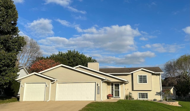 view of front of home featuring a garage and a front lawn