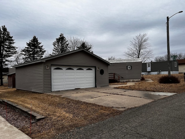 exterior space featuring a garage and an outbuilding