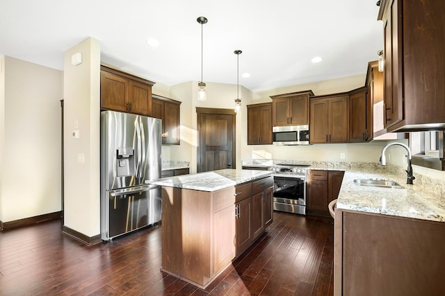 kitchen featuring dark hardwood / wood-style flooring, stainless steel appliances, a kitchen island, and sink