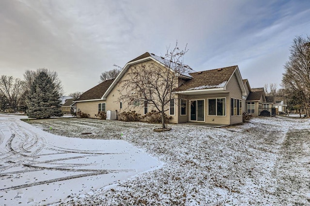 view of snow covered rear of property