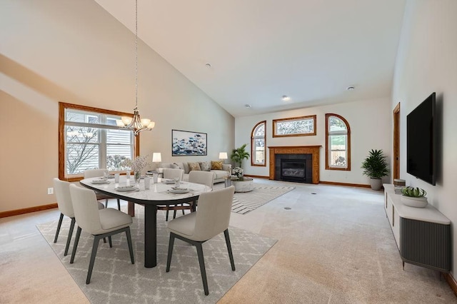 dining area featuring light carpet, high vaulted ceiling, and a healthy amount of sunlight