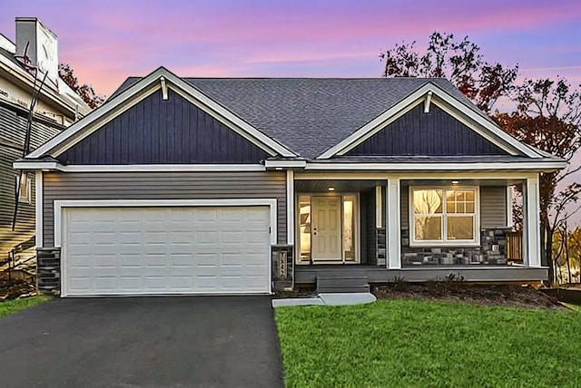 view of front of home with a yard and a garage