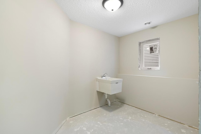 washroom with a textured ceiling