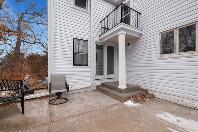 entrance to property featuring a balcony and a patio area