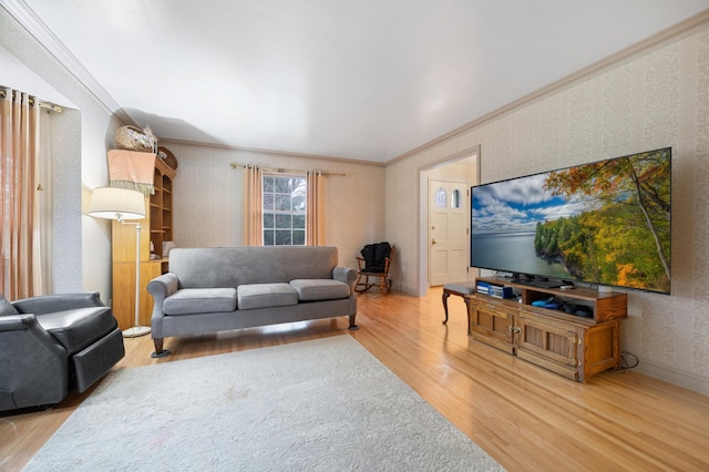 living room featuring wood-type flooring and ornamental molding