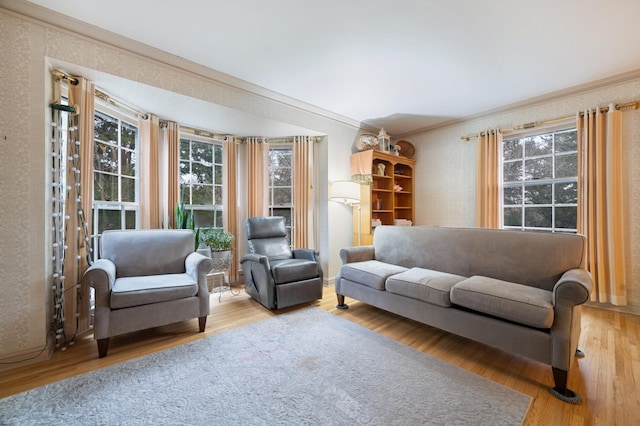 living area featuring hardwood / wood-style flooring and crown molding