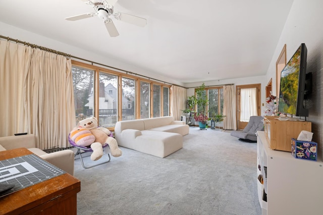 living room with carpet flooring and ceiling fan